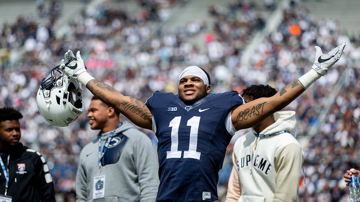 FILE - In this April 21, 2018, file photo, Penn State linebacker Micah Parsons acknowledges the crowd before the Blue-White spring college football game in State College, Pa. Last year, Parsons put together the greatest freshman season for a linebacker in Penn State’s long history. He says he learned that earning a starting spot takes more than making a bunch of tackles. (Joe Hermitt/PennLive.com via AP)