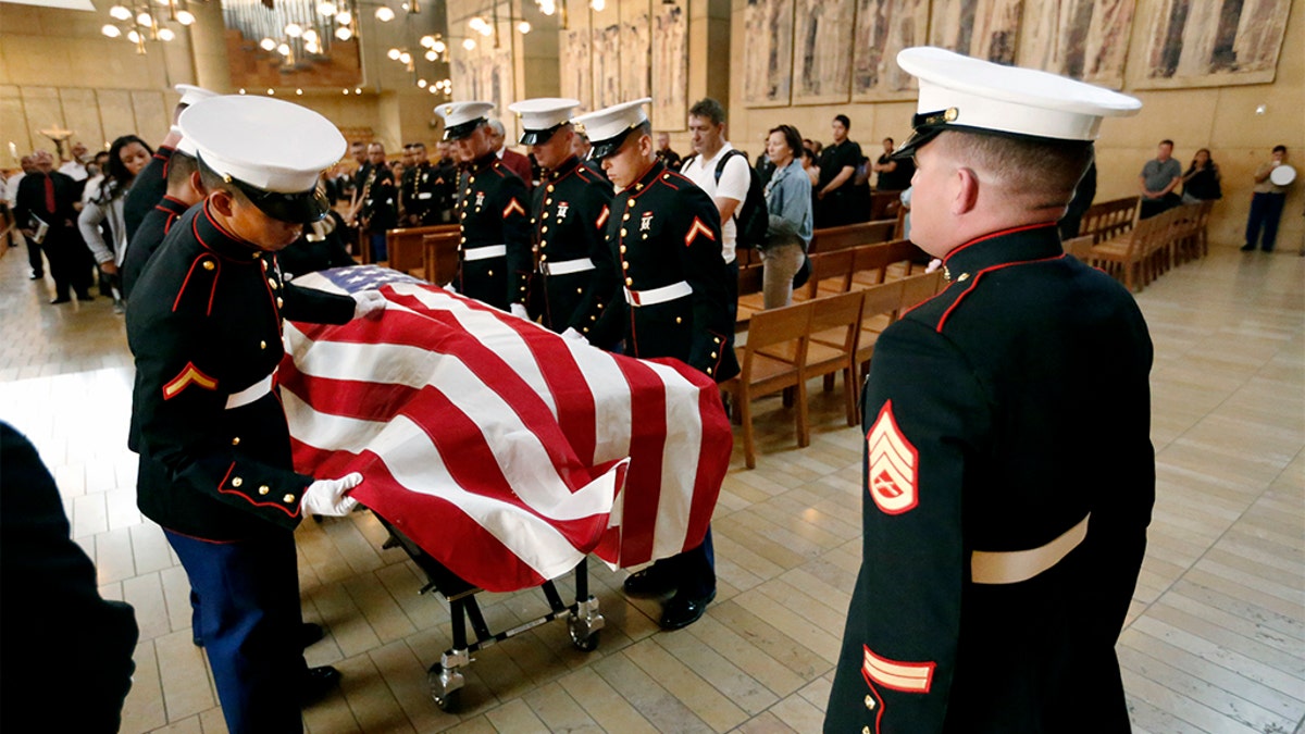 Marine pallbearers preparing the flag-draped coffin with the remains of Lance Cpl. Carlos A. Segovia-Lopez, during his funeral service in Los Angeles. (Al Seib/Los Angeles Times via AP)