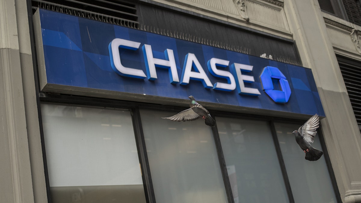 Signage is displayed outside a JPMorgan Chase &amp; Co. bank branch in New York. The bank has decided to "forgive" all outstanding balances for Canadians who use their two credit cards following an exit from the market. Victor J. Blue/Bloomberg via Getty Images