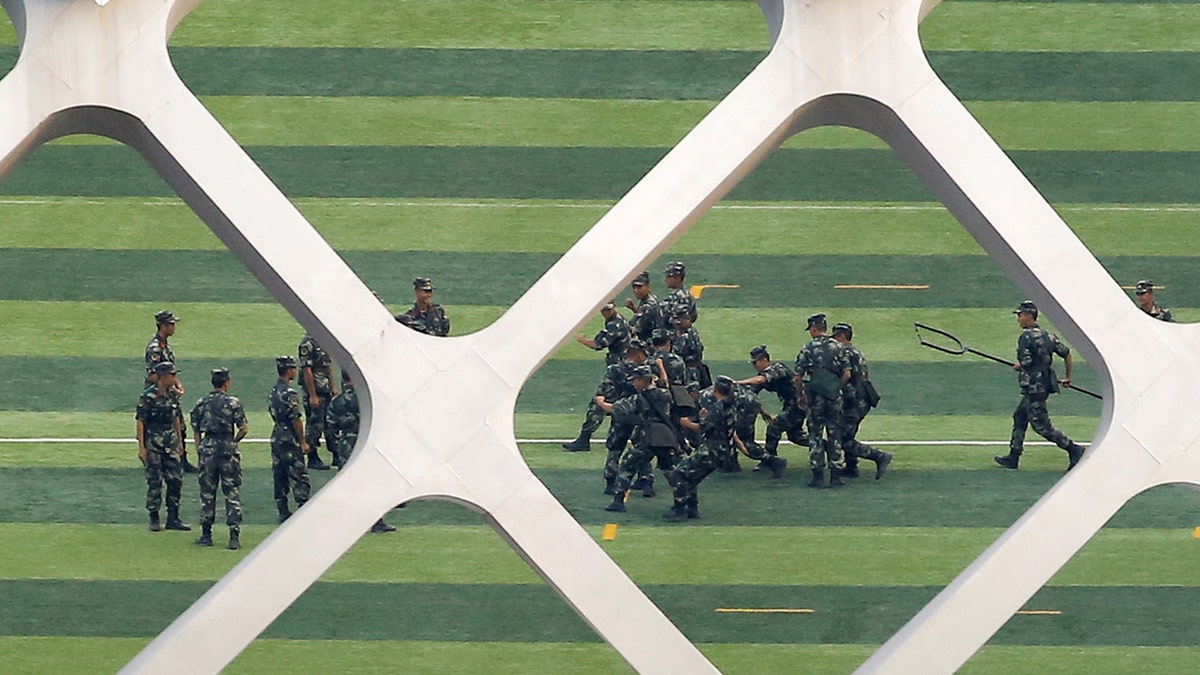 Chinese soldiers practice on the grounds of the Shenzhen Bay Sports Center in Shenzhen across the bay from Hong Kong