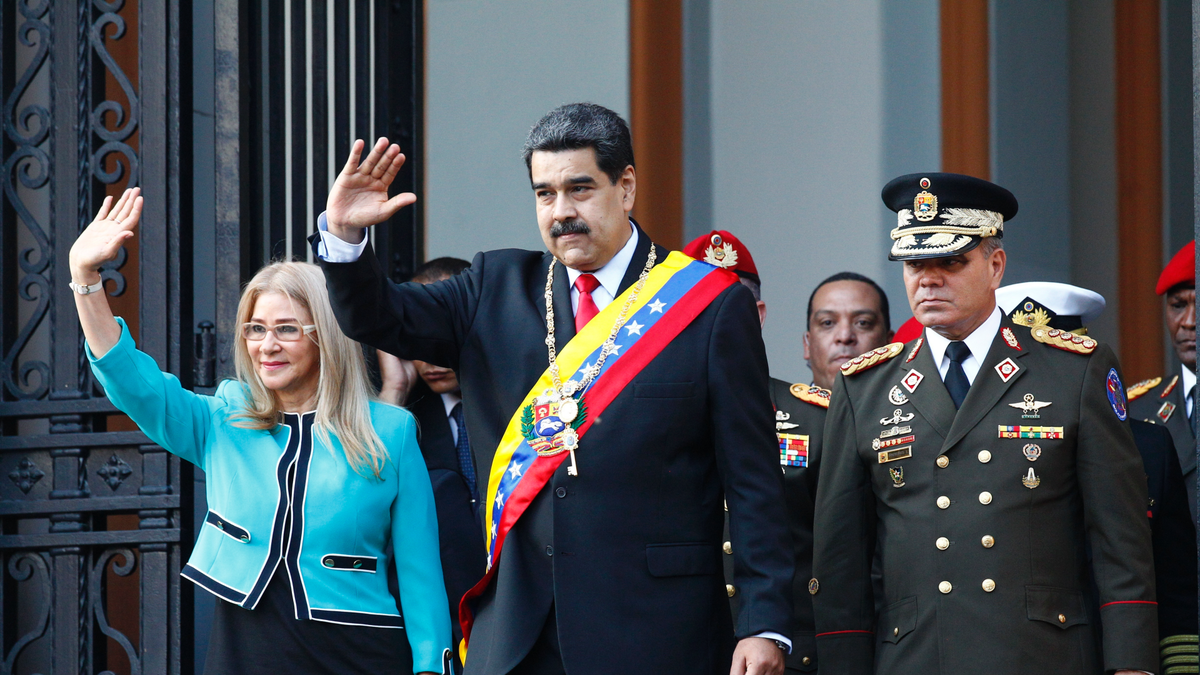 Venezuela's President Nicolas Maduro, center, and first lady Cilia Flores, wave to supporters as they leave the National Pantheon after attending a ceremony to commemorate an 1800's independence battle, in Caracas, Venezuela, Wednesday, Aug. 7, 2019. Sweeping new U.S. sanctions freeze all of the Maduro government's assets in the U.S. and even threaten to punish companies from third countries that keep doing business with his socialist administration. The first couple is accompanied by Defense Minister Gen. Padrino Lopez. (AP Photo/Leonardo Fernandez)