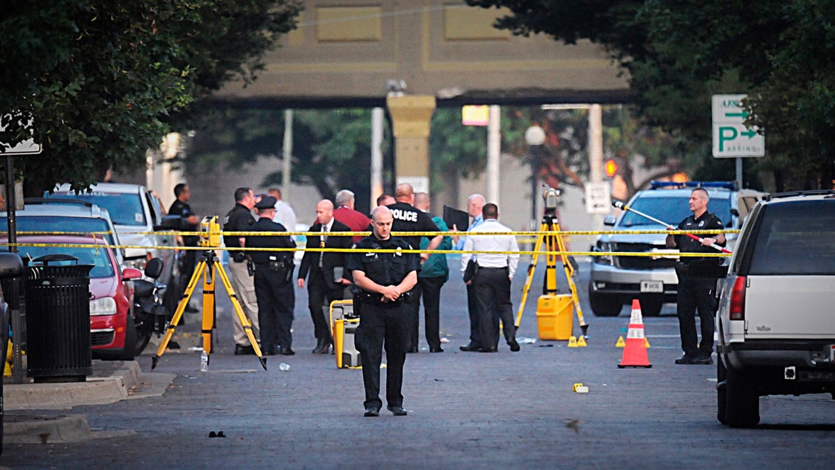 Dayton police look for evidence after a mass shooting in Dayton, Ohio on Sunday, Aug, 4, 2019.