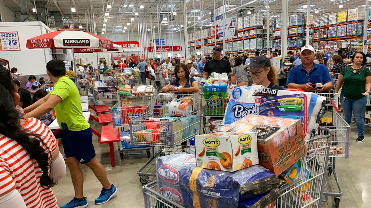 Shoppers wait in long lines at Costco, Thursday, Aug. 29, 2019, in Davie, Fla., as they stock up on supplies ahead of Hurricane Dorian. (AP Photo/Brynn Anderson)