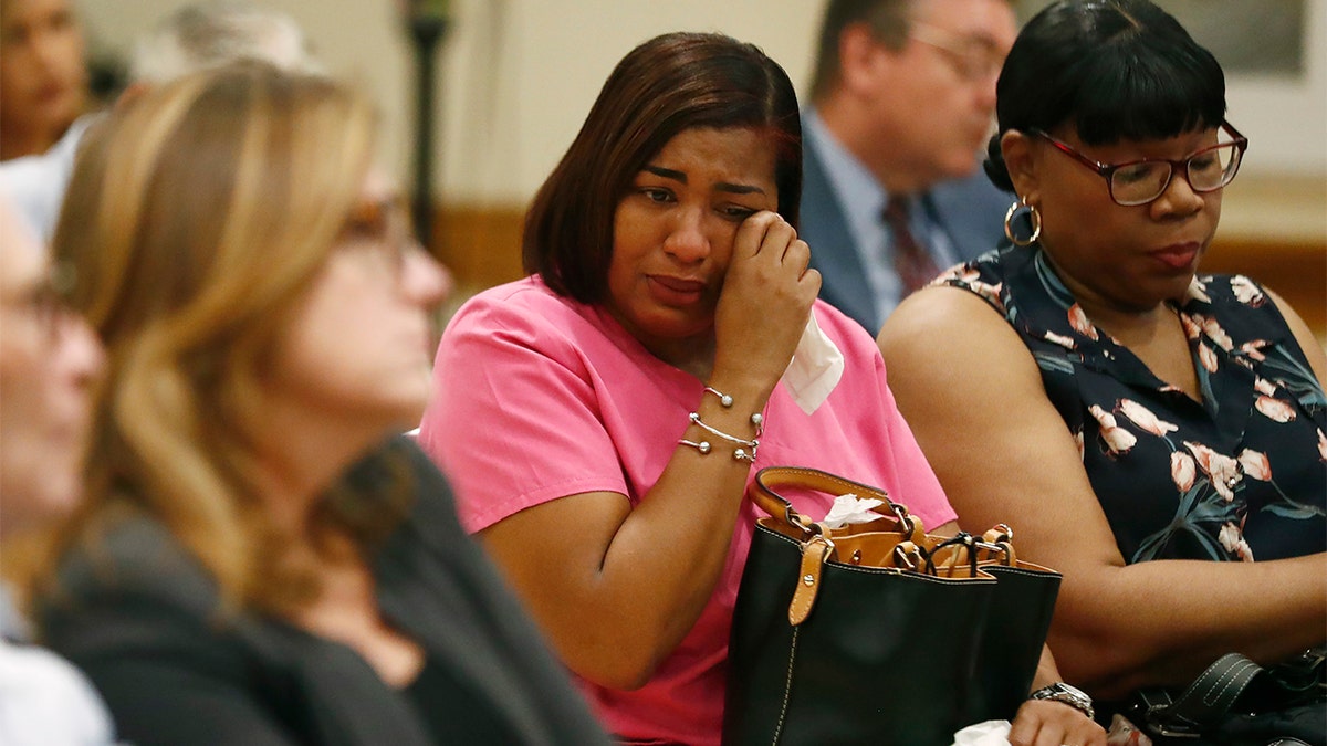 A family member of one of the patients who died crying while hearing the names read aloud at a news conference Tuesday.