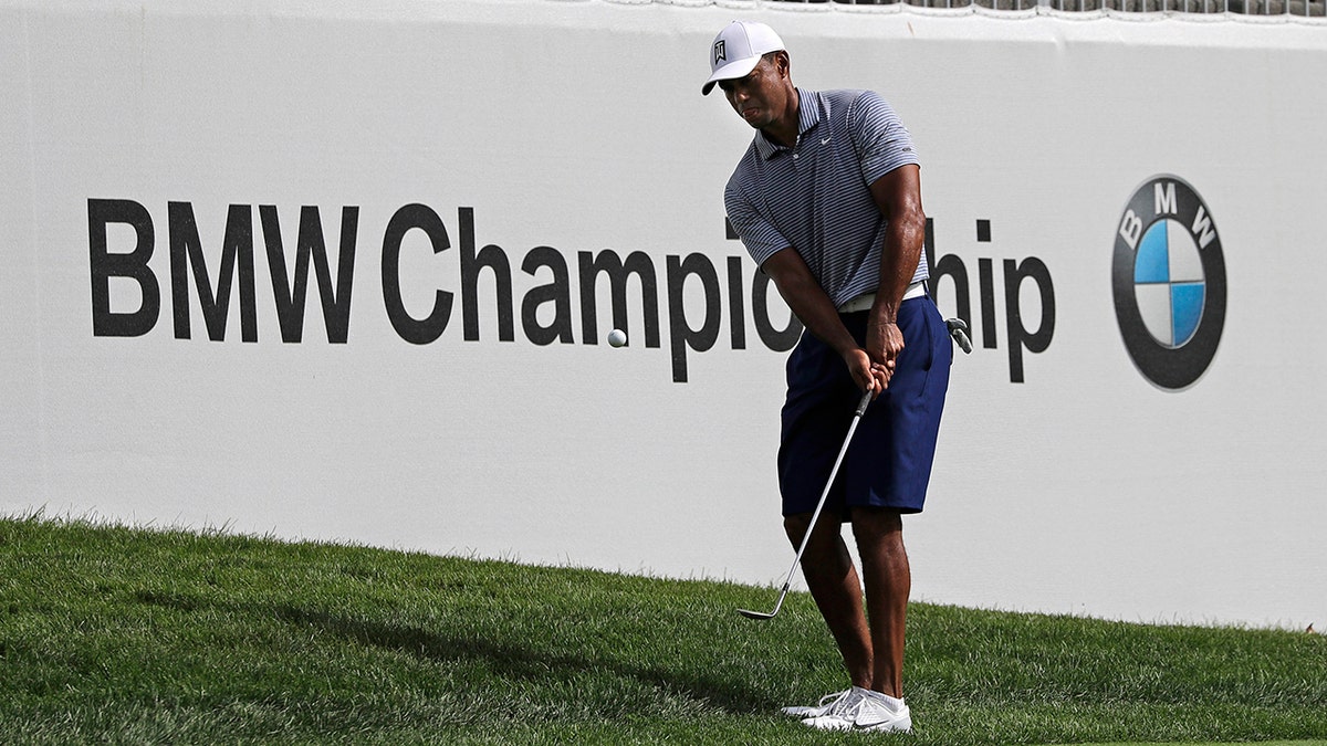 Tiger Woods chips an approach shot on the 12th hole during the pro-am round of the BMW Championship golf tournament at Medinah Country Club, Wednesday, Aug. 14, 2019, in Medinah, Ill. (AP Photo/Nam Y. Huh)