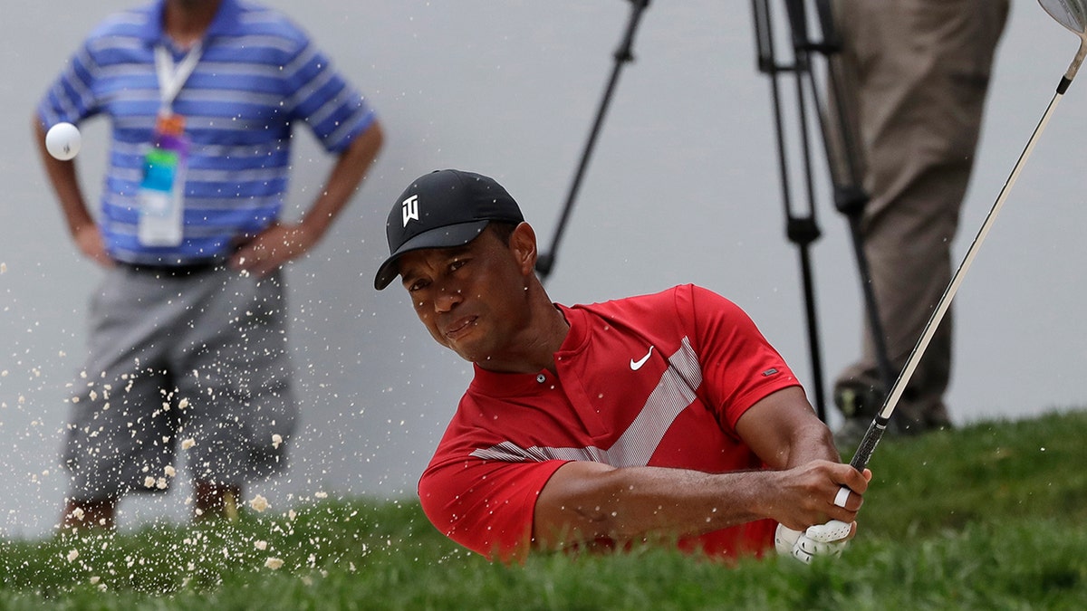 Tiger Woods hits from a bunker on the 13th hole during the final round of the BMW Championship golf tournament at Medinah Country Club, Sunday, Aug. 18, 2019, in Medinah, Ill. (AP Photo/Nam Y. Huh)