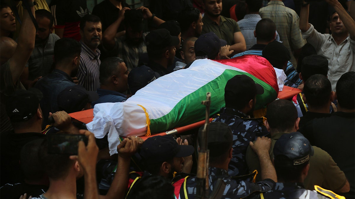 Security forces loyal to Hamas transporting the body of one of the police officers killed during his funeral in Gaza City on Wednesday.