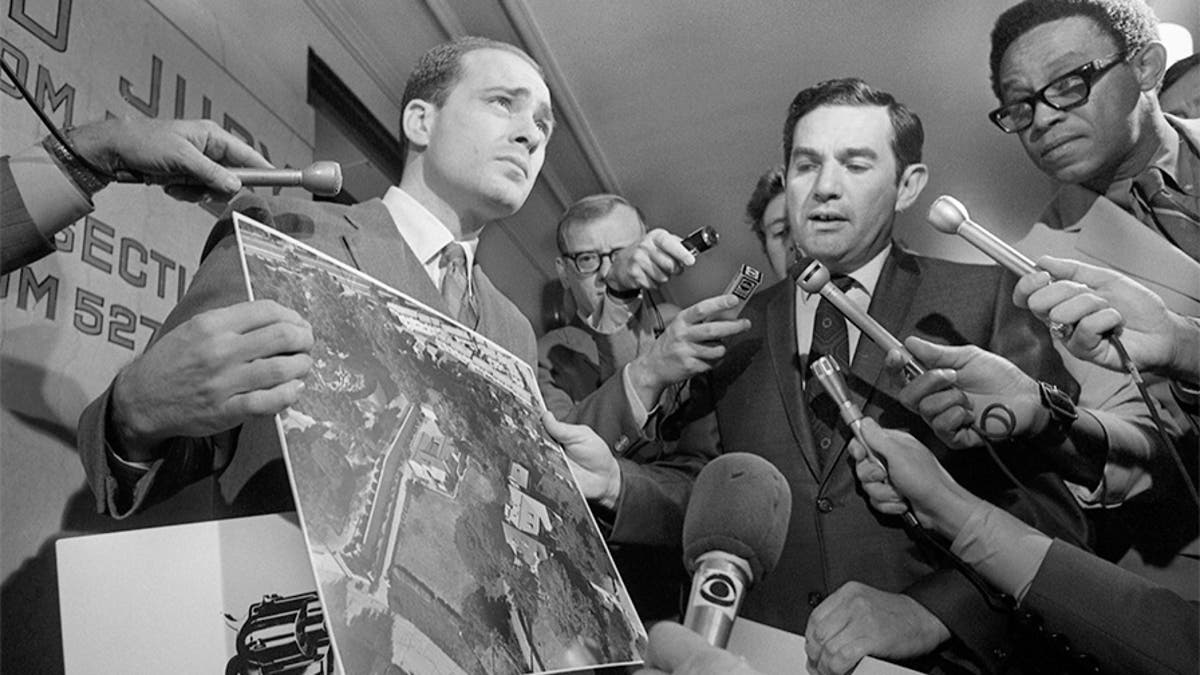 Deputy District Attorneys Aaron Stovitz (left) and Vince Bugliosi display an aerial photograph of the home of Leno and Rosemary LaBianca, 1969. — Getty