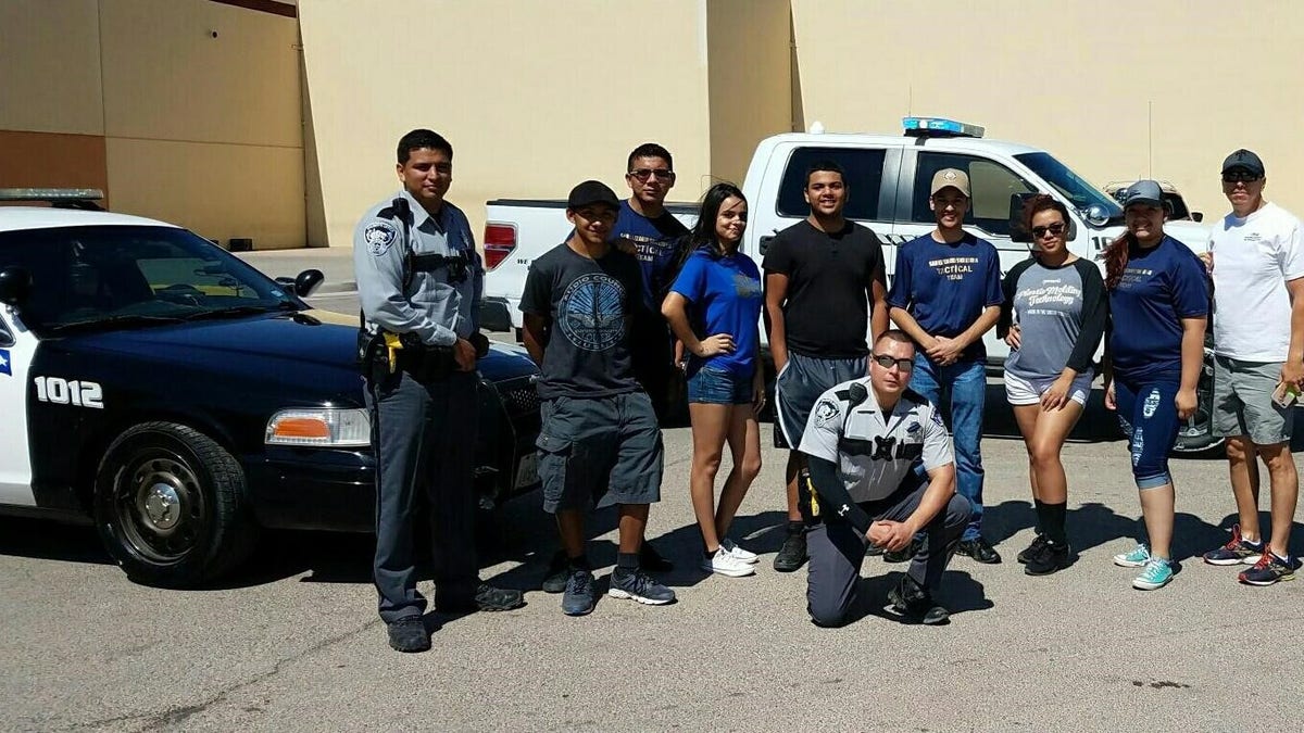 El Paso County Sheriff's Deputy Peter Herrera with teenagers he mentored.