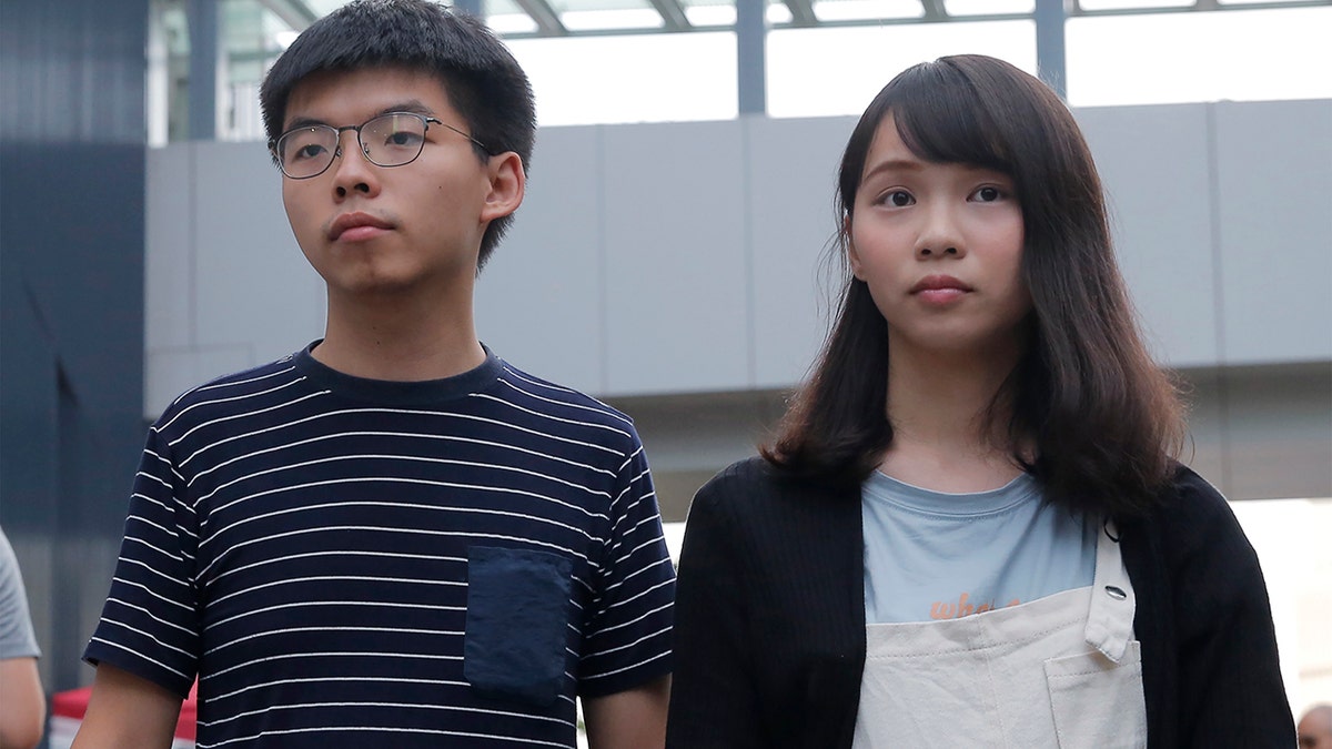 ???????Pro-democracy activists Joshua Wong, left, and Agnes Chow address reporters outside a government office in Hong Kong, June 18, 2019. (Associated Press)