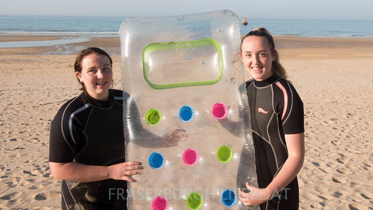 Isla Noble, 15 and her sister Eilidh, 14, help rescue the father and toddler on Monday.