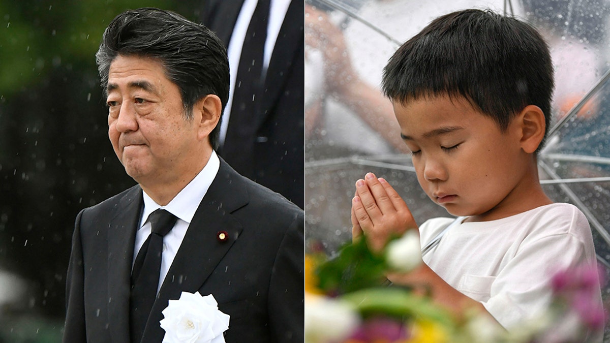 Japanese Prime Minister Shinzo Abe (left) leaves after his speech during a ceremony to mark the 74th anniversary of the atomic bombing at the Hiroshima Peace Memorial Park in Hiroshima, western Japan Tuesday, Aug. 6, 2019. A boy prays (right) for the atomic bomb victims in front of the cenotaph at the Hiroshima Peace Memorial Park in Hiroshima.
