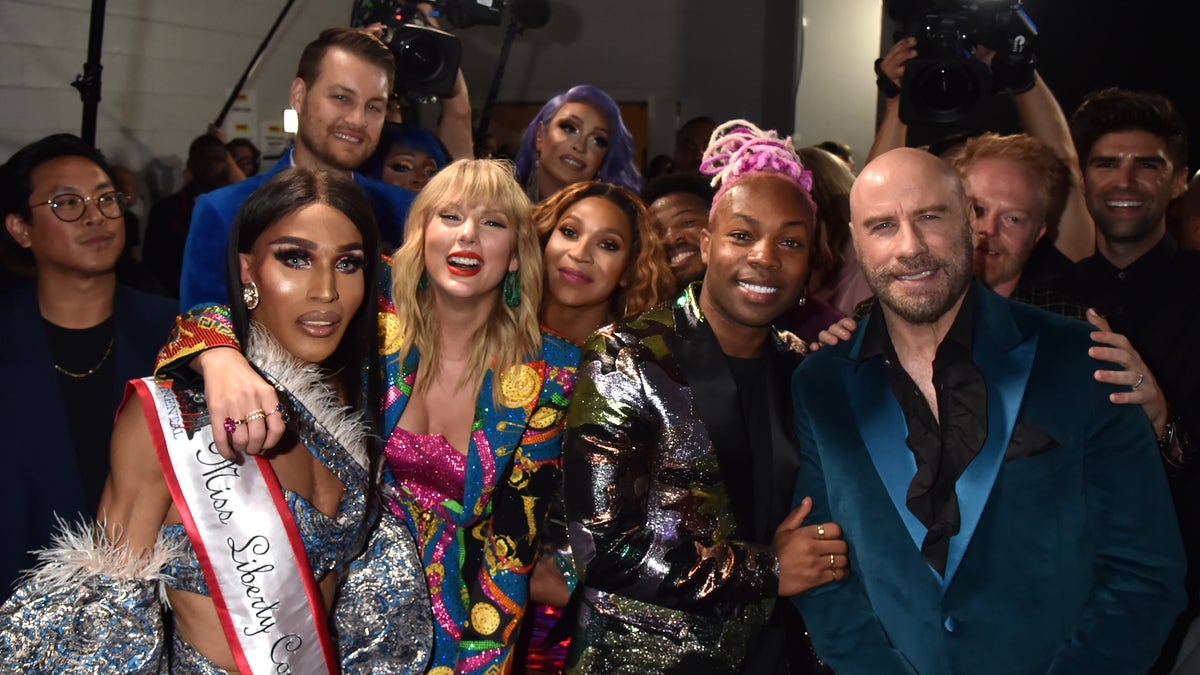 Taylor Swift, Todrick Hall, John Travolta, and Jesse Tyler Ferguson pose backstage during the 2019 MTV Video Music Awards at Prudential Center on August 26, 2019 in Newark, New Jersey. (Photo by Jeff Kravitz/FilmMagic)