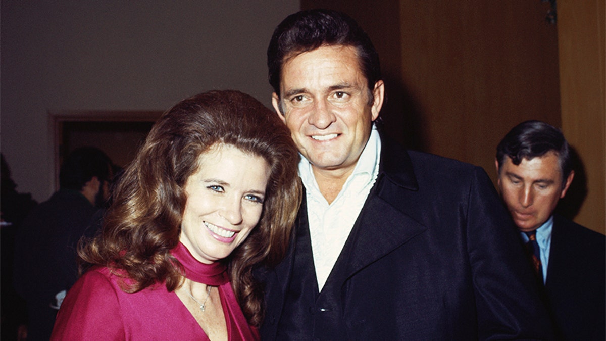 Married country singers Johnny Cash and June Carter Cash pose for a portrait at an event on September 1969 in California.​​​