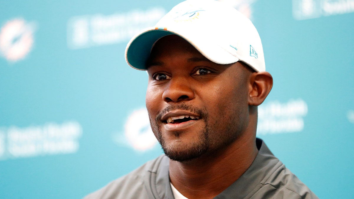 Miami Dolphins head coach Brian Flores speaks to members of the media before the start of practice at the NFL football team's training camp, Monday, Aug. 19, 2019, in Davie, Fla. (AP Photo/Wilfredo Lee)