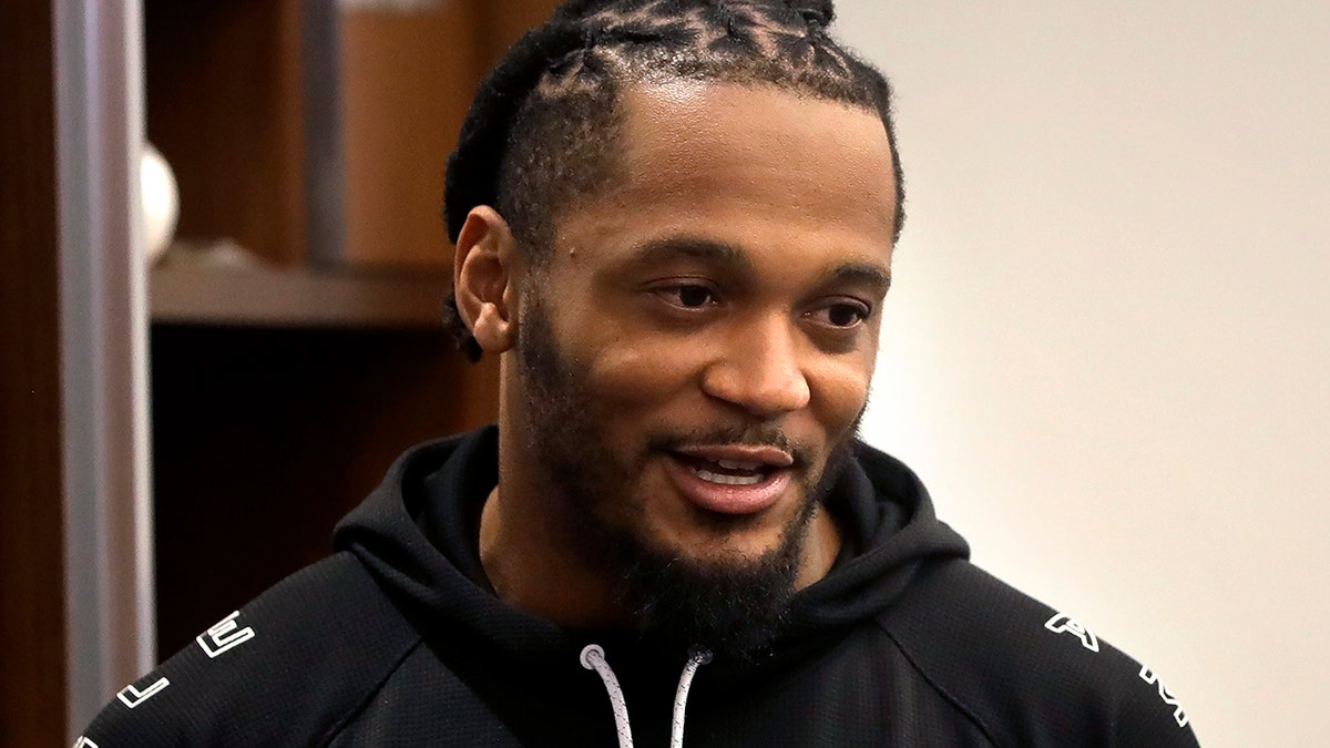 New England Patriots strong safety Patrick Chung speaks with a reporter in the team's locker room following an NFL football practice Monday, Aug. 26, 2019, in Foxborough, Mass. (AP Photo/Steven Senne)