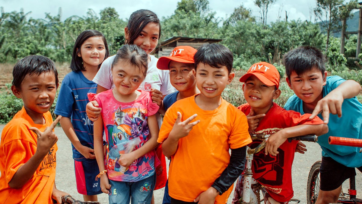 Nia, pictured in the My Little Pony t-shirt with friends, was born with special needs and has been a blessing to her community.