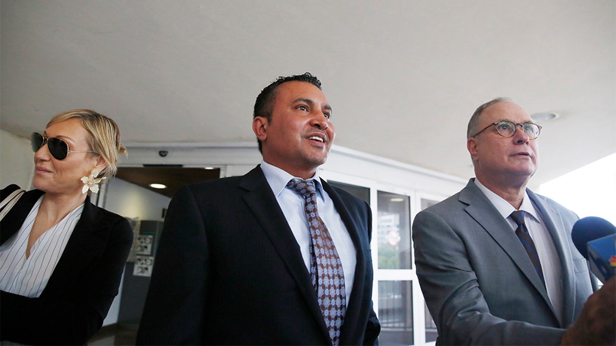 Attorneys for the defendants, Lawrence Hashish, center, David Frankel, right, and paralegal Juliana Marulanda, at the Broward County Jail on Monday.