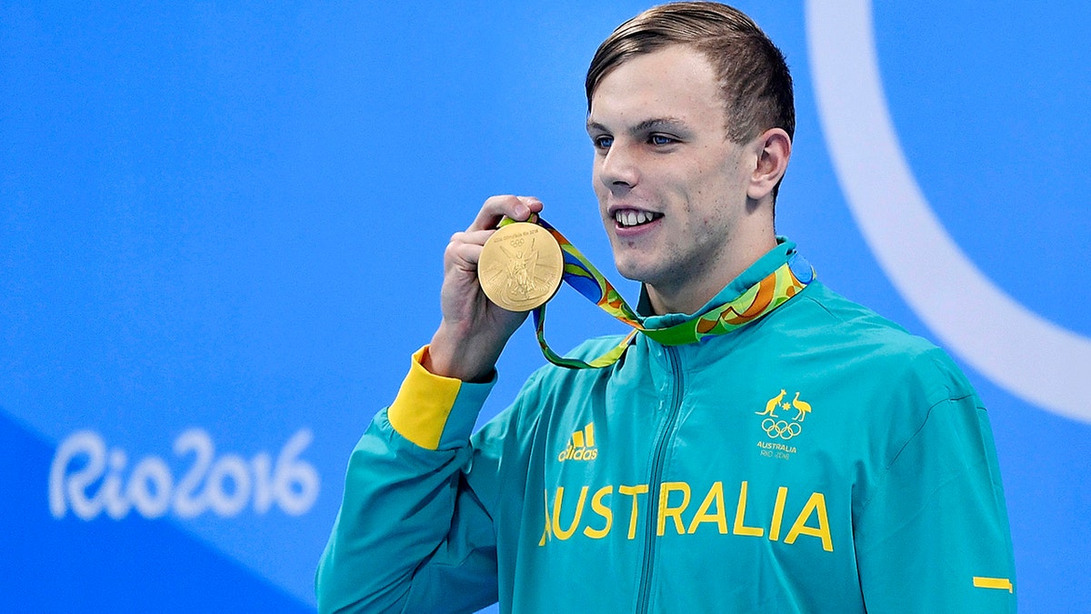 FILE - In this Aug. 11, 2016, file photo, Australia's Kyle Chalmers shows off his gold medal during the men's 100-meter freestyle medals ceremony during the swimming competitions at the 2016 Summer Olympics in Rio de Janeiro, Brazil. Olympic swimming gold medalist Chalmers has had a third operation on his heart in a bid to keep his preparations for next year's Tokyo Olympics on track. The 21-year-old Australian swimmer posted an update on Instagram after the operation on Monday, Aug. 26, 2019, saying "3rd time lucky ... fingers crossed today's heart surgery fixed the problem once and for all." (AP Photo/Martin Meissner, File)