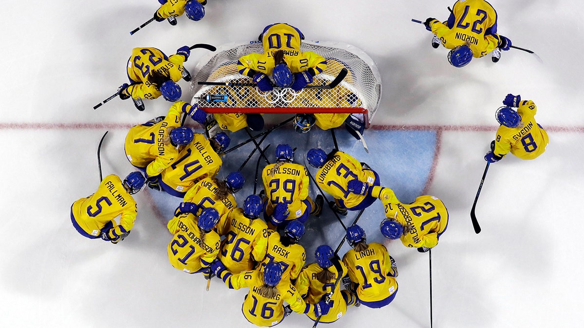 FILE - In this Feb. 2, 2018, file photo, players from Sweden gather before the preliminary round of the women's hockey game against the combined Koreas at the 2018 Winter Olympics in Gangneung, South Korea. (AP Photo/Kiichiro Sato, File)