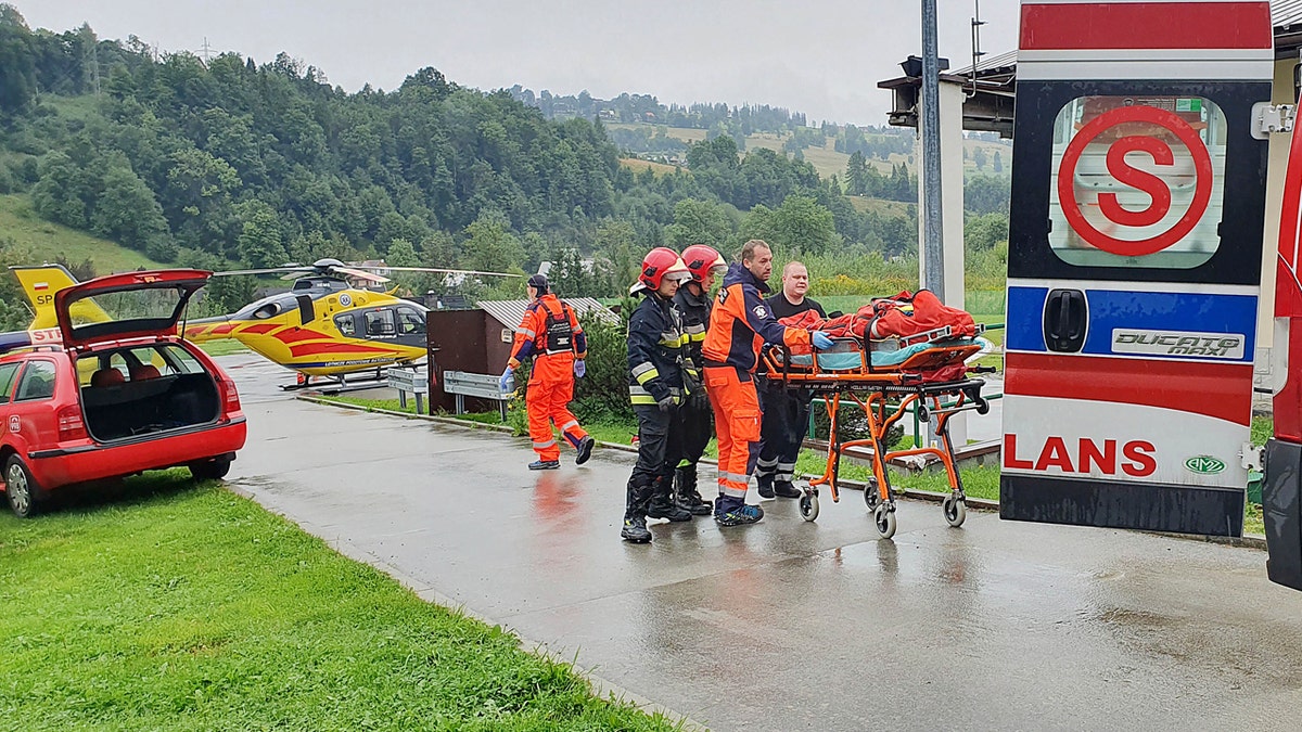 Rescue crews with the first people injured by a lightning strike that struck in Poland's southern Tatra Mountains during a sudden thunderstorm Thursday.