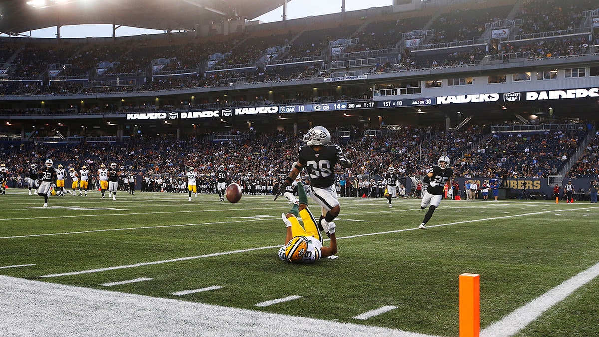 Green Bay Packers' Equanimeous St. Brown (19) misses the pass in the modified end zone as Oakland Raiders' Keisean Nixon (38) defends during the first half of an NFL preseason football game Thursday, Aug. 22, 2019, in Winnipeg, Manitoba. (Associated Press)