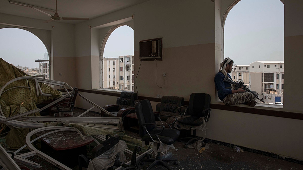 A soldier guards the site of a deadly attack inside the Sheikh Othman police station in Aden, Yemen, Thursday, Aug. 1, 2019. Yemen's rebels have fired a ballistic missile at a military parade in the southern port city of Aden as coordinated suicide bombings targeted the police station in another part of the city. The attacks killed at least 51 people and wounded dozens.