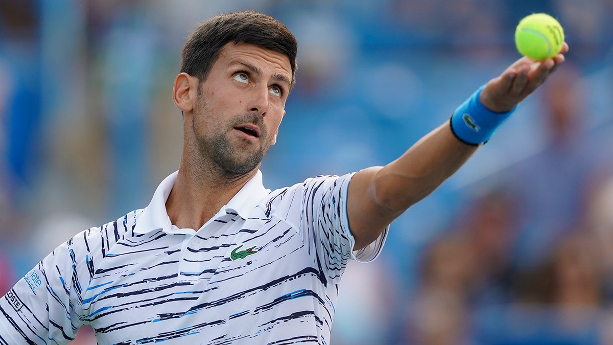 Novak Djokovic, of Serbia, tosses the ball on a serve to Daniil Medvedev, of Russia, during the Western &amp; Southern Open tennis tournament Saturday, Aug. 17, 2019, in Mason, Ohio. (Associated Press)