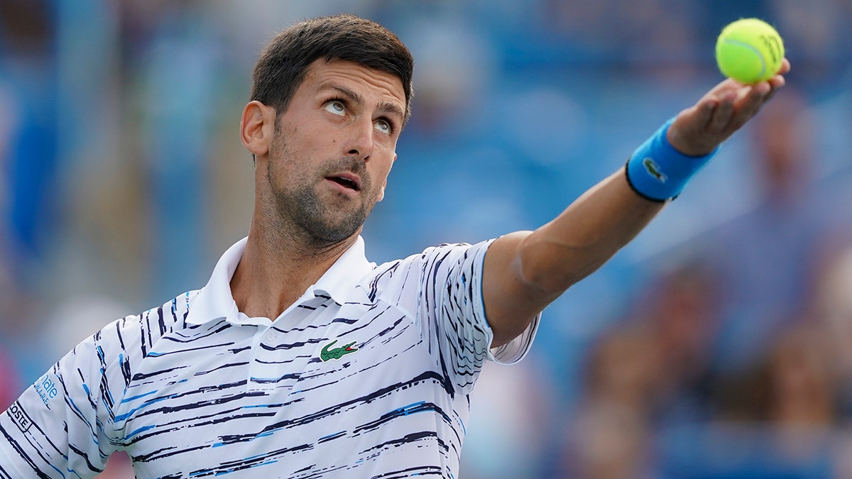Novak Djokovic, of Serbia, tosses the ball on a serve to Daniil Medvedev, of Russia, during the Western & Southern Open tennis tournament Saturday, Aug. 17, 2019, in Mason, Ohio. (Associated Press)