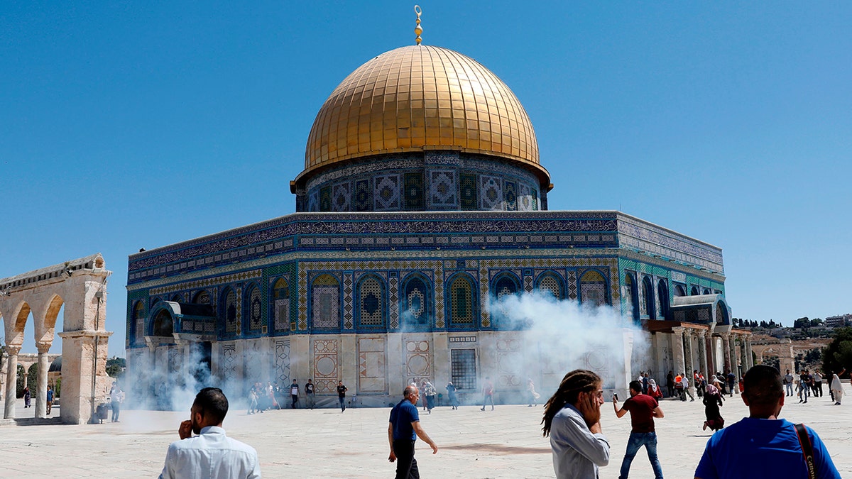 Palestinians running for cover from sound grenades fired by Israeli security forces outside the Jerusalem holy site last week.