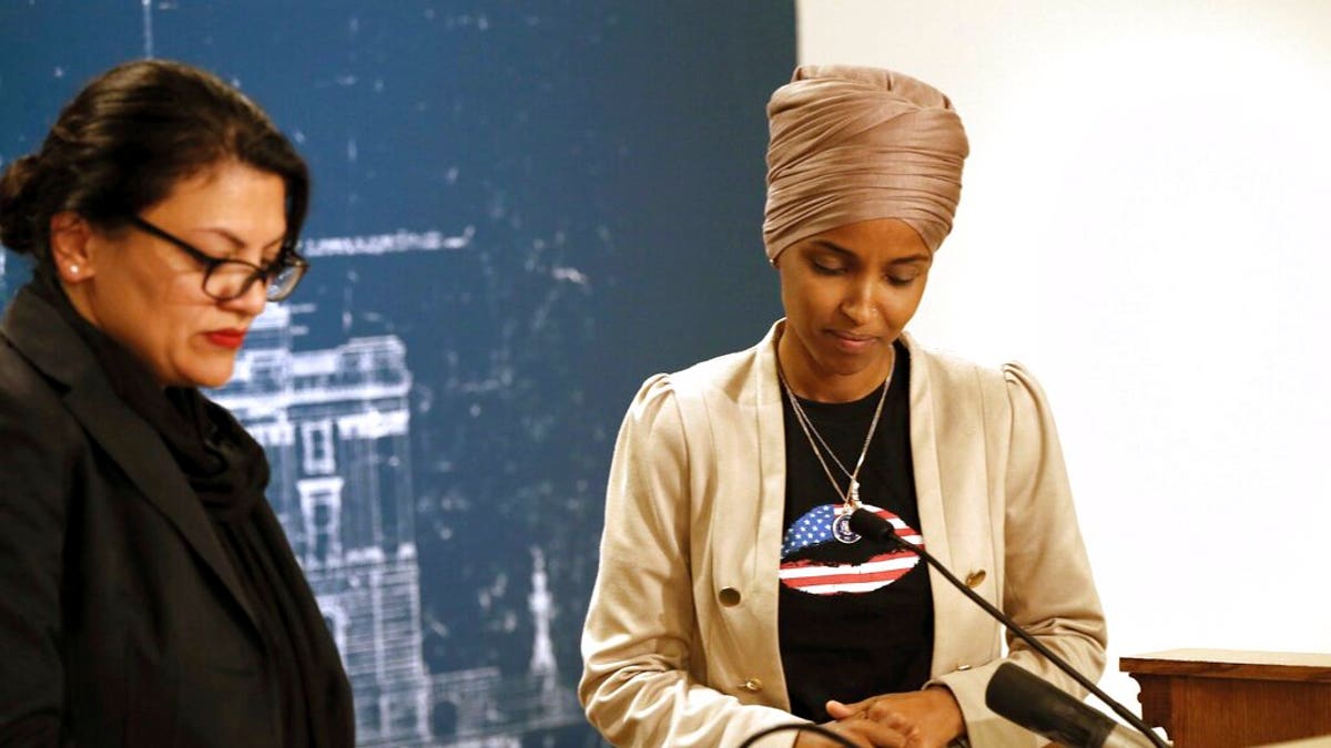 Rep. Ilhan Omar, D-Minn., right, and Rep. Rashida Tlaib, D-Mich., take a quiet moment as they talked about Israel's refusal to allow them to visit the country during a news conference Monday, Aug. 19, 2019 at the State Capitol in St. Paul, Minn. (AP Photo/Jim Mone)