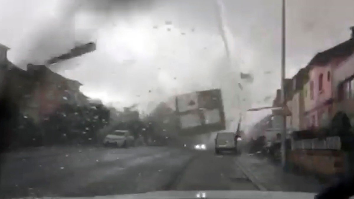 A tornado hurls objects, including doors and roofs, through the air, as seen from inside a car with a cracked windshield, in Pettingen, Luxembourg, Friday Aug. 9, 2019.