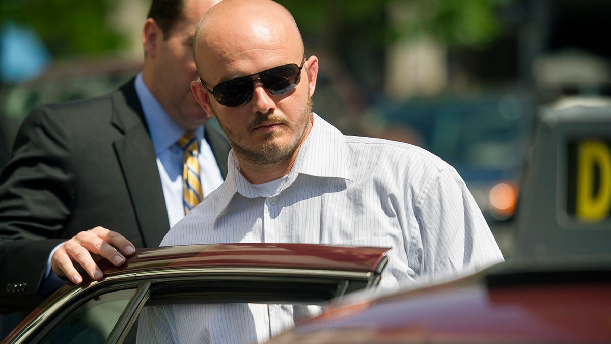 In this June 11, 2014, photo, former Blackwater Worldwide guard Nicholas Slatten leaves federal court in Washington after the start of his trial. (AP Photo/Cliff Owen, File)