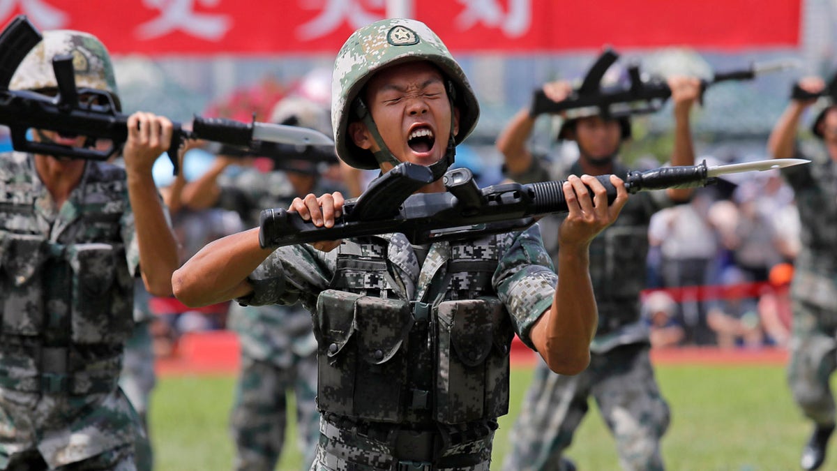 FILE - In this June 30, 2019, file photo, soldiers of Chinese People's Liberation Army (PLA) demonstrate their skill during an open day of Stonecutter Island naval base, in Hong Kong, to mark the 22nd anniversary of Hong Kong handover to China.