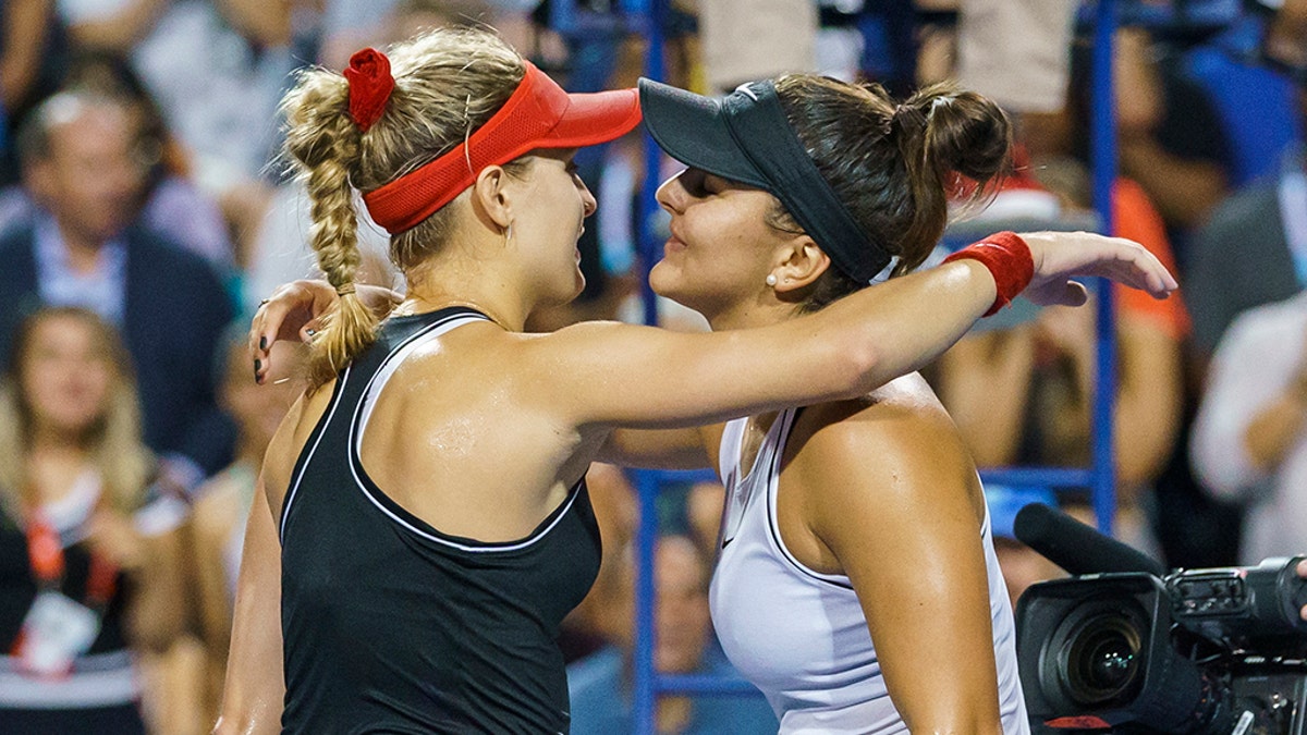 Bianca Andreescu, right, embraces Eugenie Bouchard, both of Canada, after Andreescu's win in the first round of the Rogers Cup women’s tennis tournament Tuesday, Aug. 6, 2019, in Toronto. (Mark Blinch/The Canadian Press via AP)