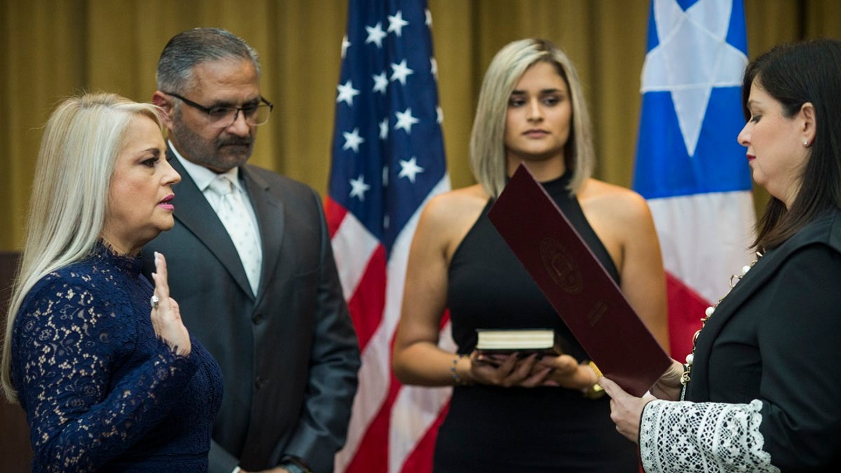 Justice Secretary Wanda Vazquez is sworn in as governor of Puerto Rico by Supreme Court Justice Maite Oronoz Wednesday in San Juan. (AP Photo/Dennis M. Rivera Pichardo)