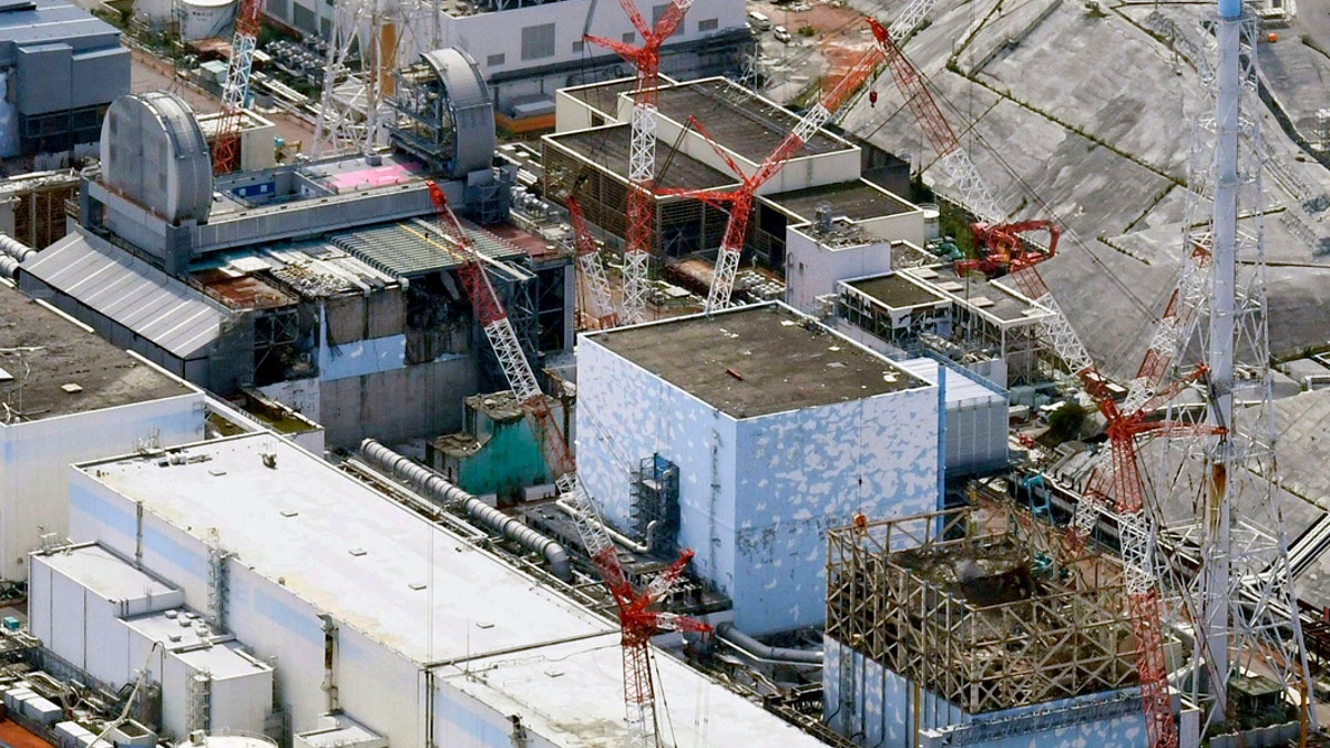 This Sept. 4, 2017, aerial file photo shows Fukushima Dai-ichi nuclear power plant reactors, bottom from right, Unit 1, Unit 2 and Unit 3, in Okuma town, Fukushima prefecture, northeastern Japan.