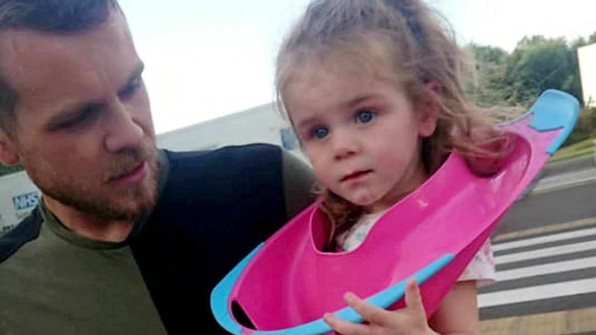 Two-year-old Josie was rushed to the emergency room to remove the toilet seat from her head. (SWNS)
