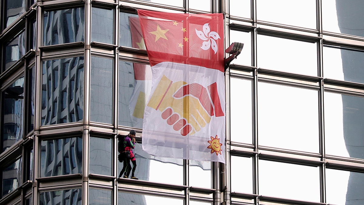 French urban climber Alain Robert climbs the Cheung Kong Center building in Hong Kong, China, August 16, 2019.