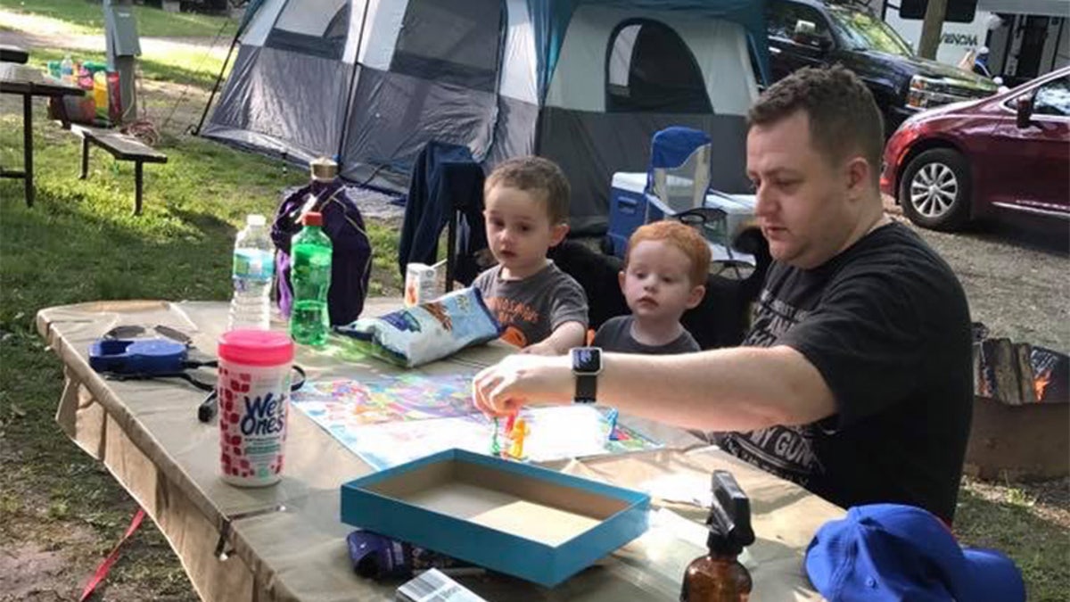 Becki Keltner says Jacob "loved his family above everything" and "cared about everyone." He is pictured here playing a board game with his two children, Caleb, far left, and Carson, center.