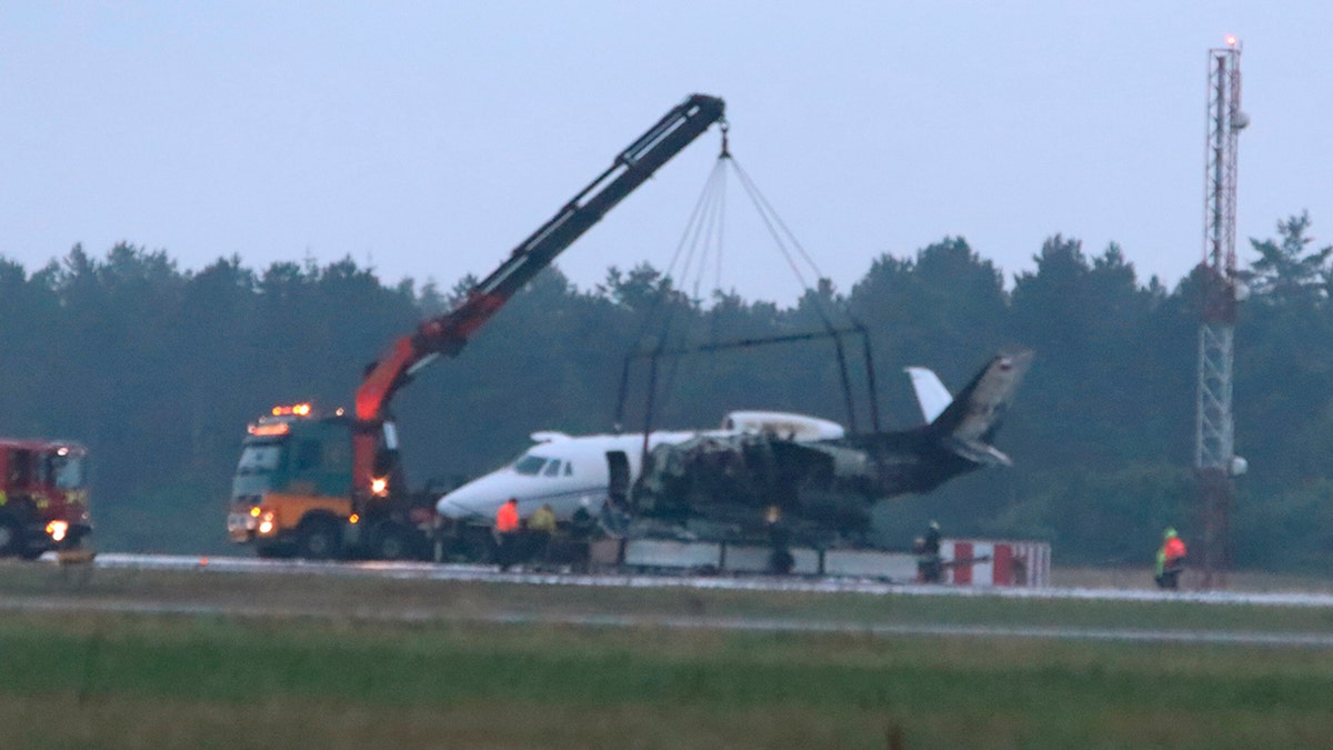 A private aircraft is recovered after it caught fire on landing at Aarhus Airport in Tirstrup, Denmark, Tuesday, Aug. 6, 2019.