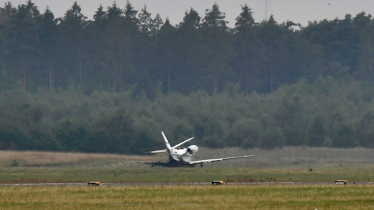 A private aircraft lays off the runway after it caught fire on landing at Aarhus Airport in Tirstrup, Denmark, Tuesday, Aug. 6, 2019.