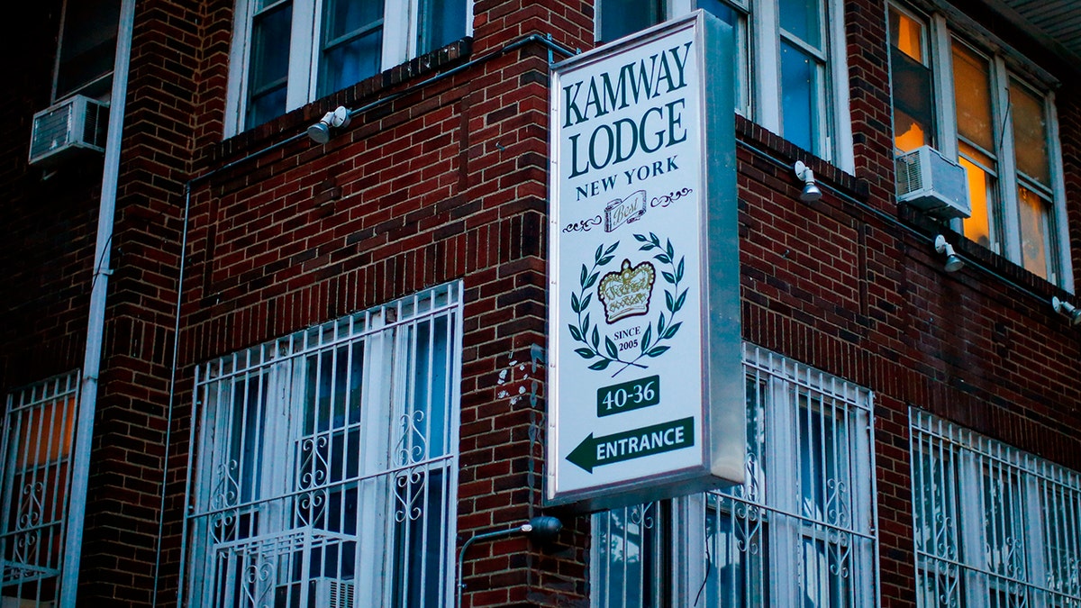 A sign points to the entrance of the Kamway Lodge Thursday, Aug. 22, 2019, in the Queens borough of New York. Police say the body of Andrea Zamperoni, a chef at a popular restaurant in New York's Grand Central Terminal who went missing the previous weekend, was found at the hostel earlier in the day. (AP Photo/Eduardo Munoz Alvarez)