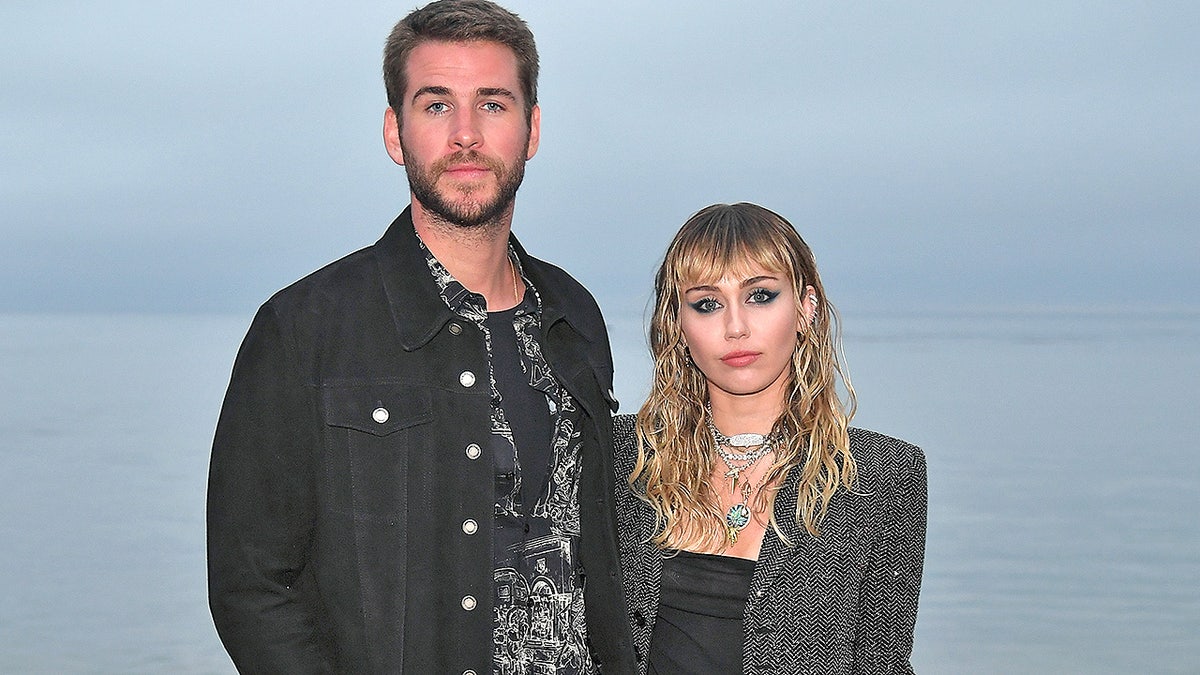 MALIBU, CALIFORNIA - JUNE 06: (L-R) Liam Hemsworth and Miley Cyrus attend the Saint Laurent Mens Spring Summer 20 Show on June 06, 2019 in Paradise Cove Malibu, California. (Photo by Neilson Barnard/Getty Images)