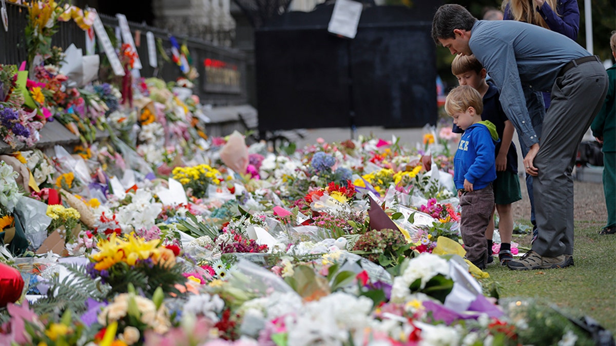 Mourners lay flowers on a wall at the Botanical Gardens in Christchurch, New Zealand, in March.
