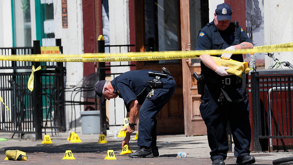 Authorities retrieve evidence markers at the scene of a mass shooting in Dayton, Ohio.