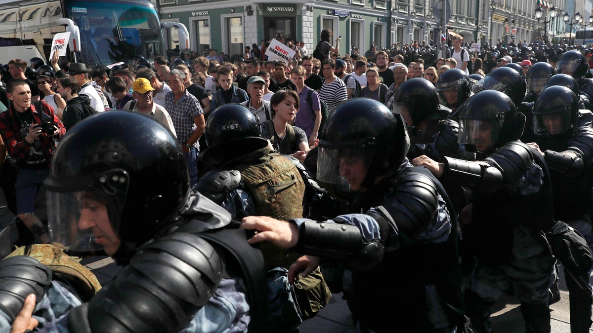 In this file photo dated Saturday, July 27, 2019, police block a street during an unsanctioned rally in the center of Moscow, Russia.