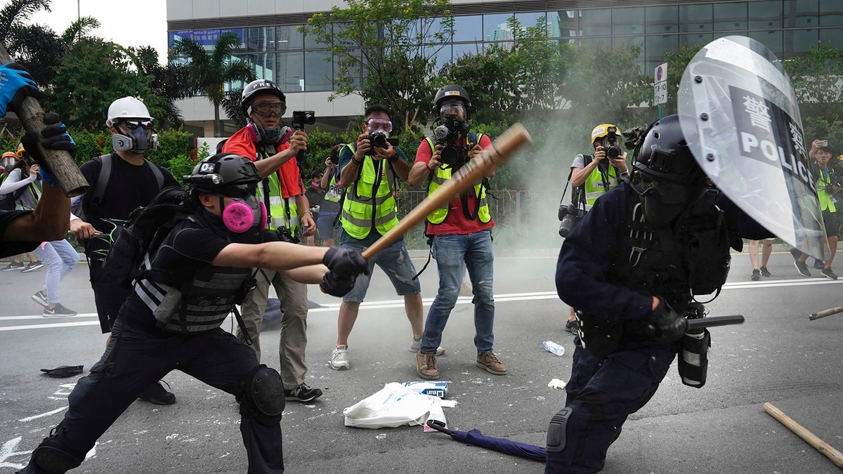 Police and demonstrators clash during a protest in Hong Kong, Saturday, Aug. 24, 2019. Chinese police said Saturday they released an employee at the British Consulate. (AP Photo/Vincent Yu)