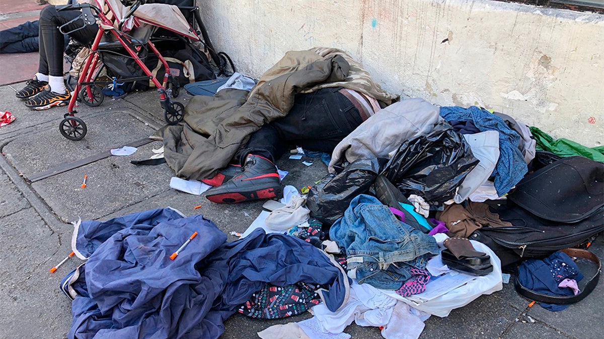 Sleeping people, discarded clothes and used needles are seen on a street in the Tenderloin neighborhood in San Francisco last month (AP)