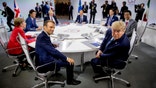 French President Emmanuel Macron, center left, and President Donald Trump, center right, participate in a G-7 Working Session on the Global Economy, Foreign Policy, and Security Affairs the G-7 summit in Biarritz, France, Sunday, Aug. 25, 2019. Also pictured is German Chancellor Angela Merkel, left, Canadian Prime Minister Justin Trudeau, second from left, British Prime Minister Boris Johnson, third from left, President of the European Council Donald Tusk, center, Italian Prime Minister Giuseppe Conte, top second from right, and Japanese Prime Minister Shinzo Abe, right. (AP Photo/Andrew Harnik, Pool)
